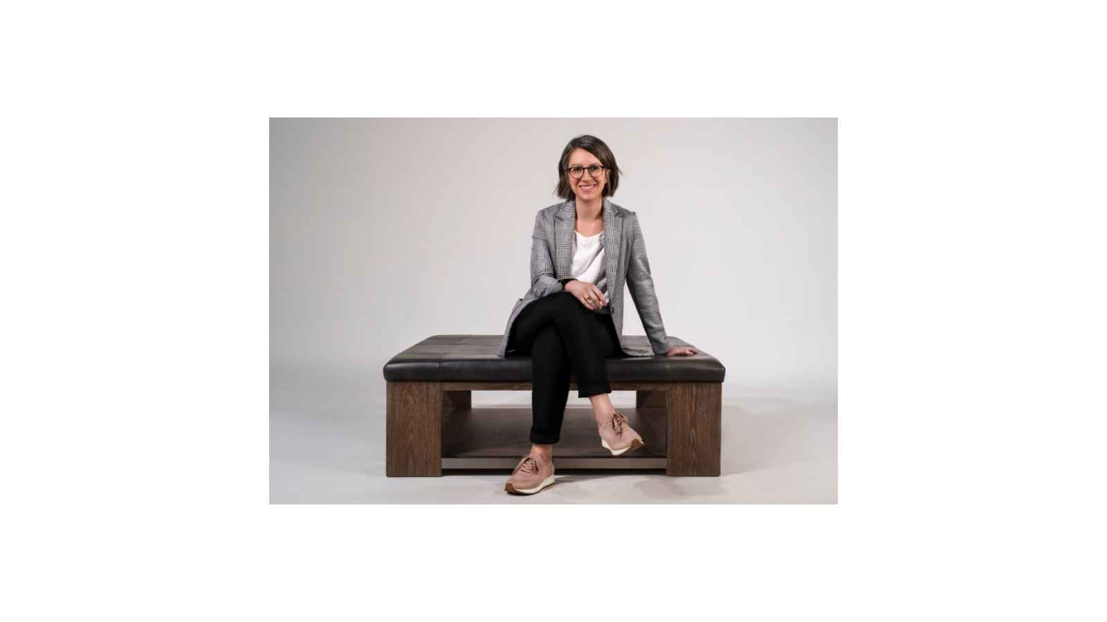 Amy Sardone sitting on a bench, smiling