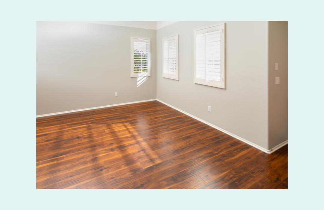 Bright room with clean white baseboards and hardwood floor.
