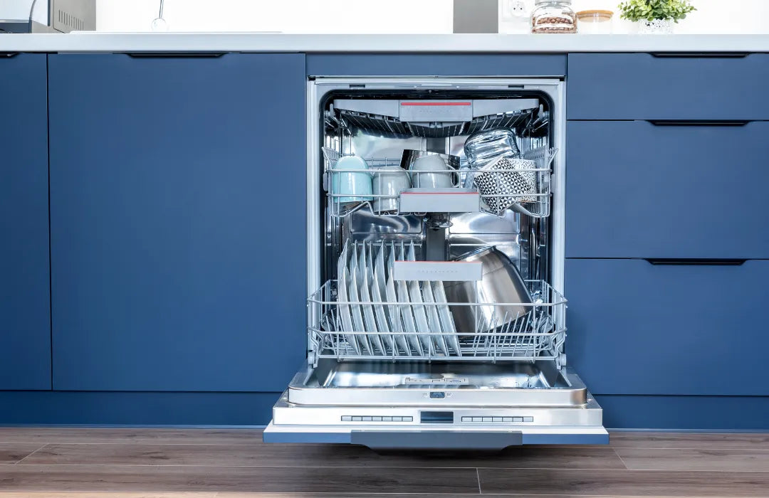 Open dishwasher with clean dishes inside and blue cabinets in a modern kitchen.