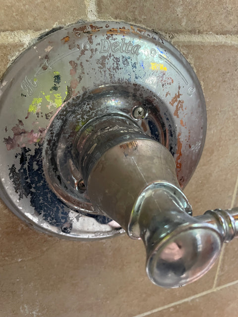 Chrome shower handle covered in scale